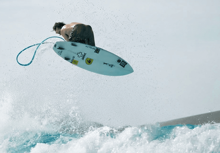 Surfer riding through whitewater